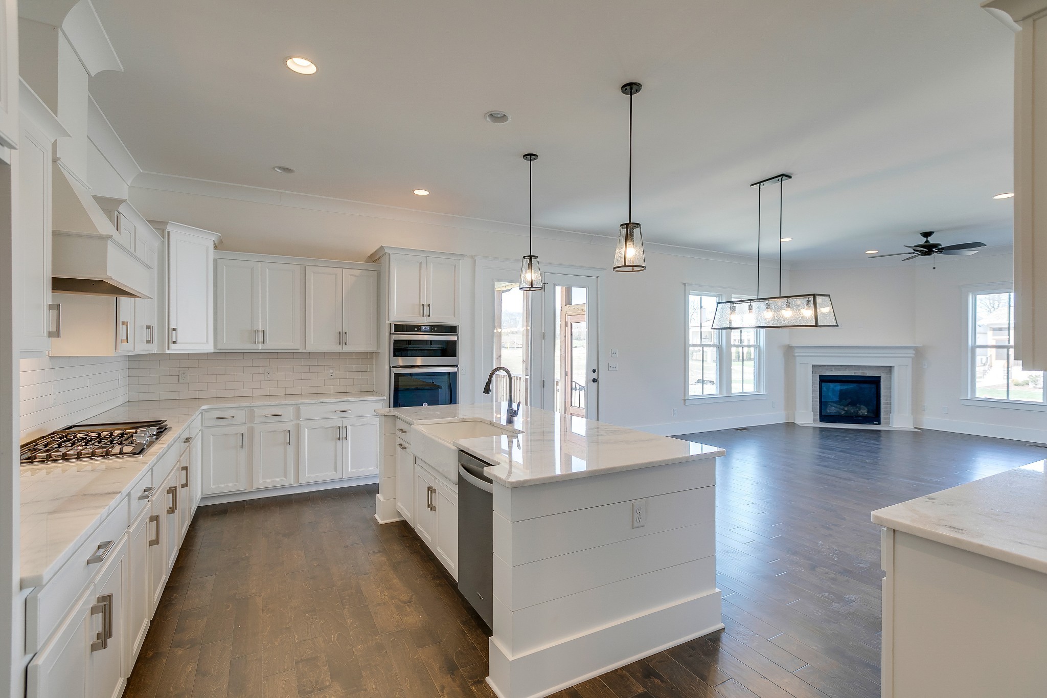 392 Dewar Drive Franklin, TN 37064 - Photo 7 of 13 a large kitchen with white cabinets and stainless steel appliances