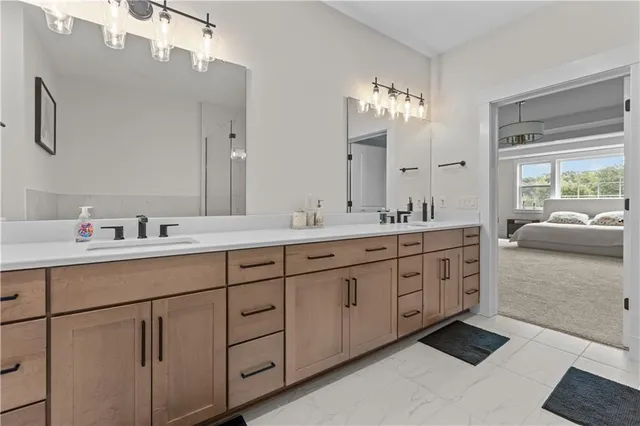 a spacious bathroom with double sink and a mirror