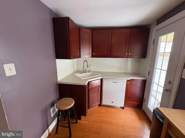 a kitchen with a wooden floor and a sink