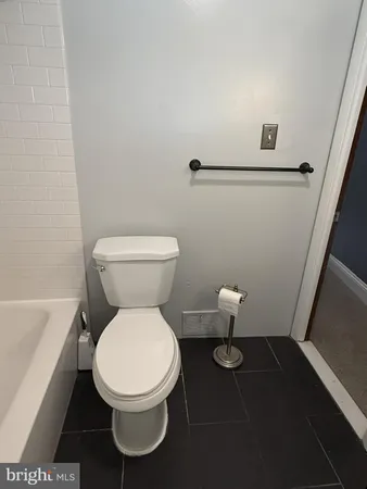 a white toilet sitting next to a bathroom sink