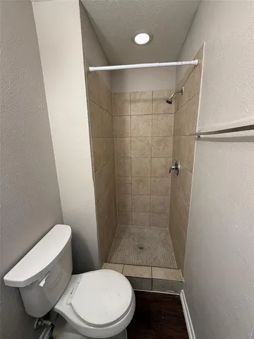 a bathroom with a toilet and a shower