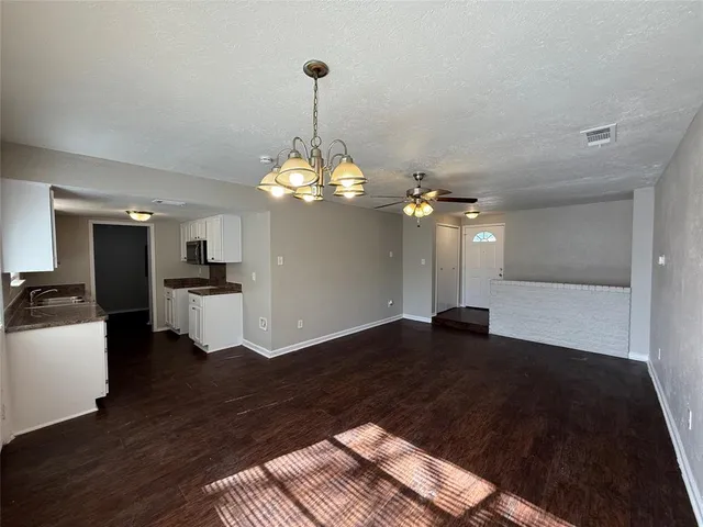a view of a kitchen with a sink dishwasher a refrigerator and a chandelier