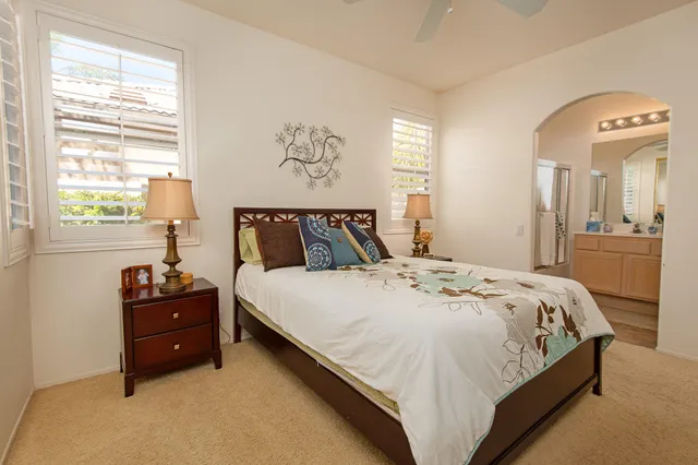 a bedroom with a bed and a painting on the wall