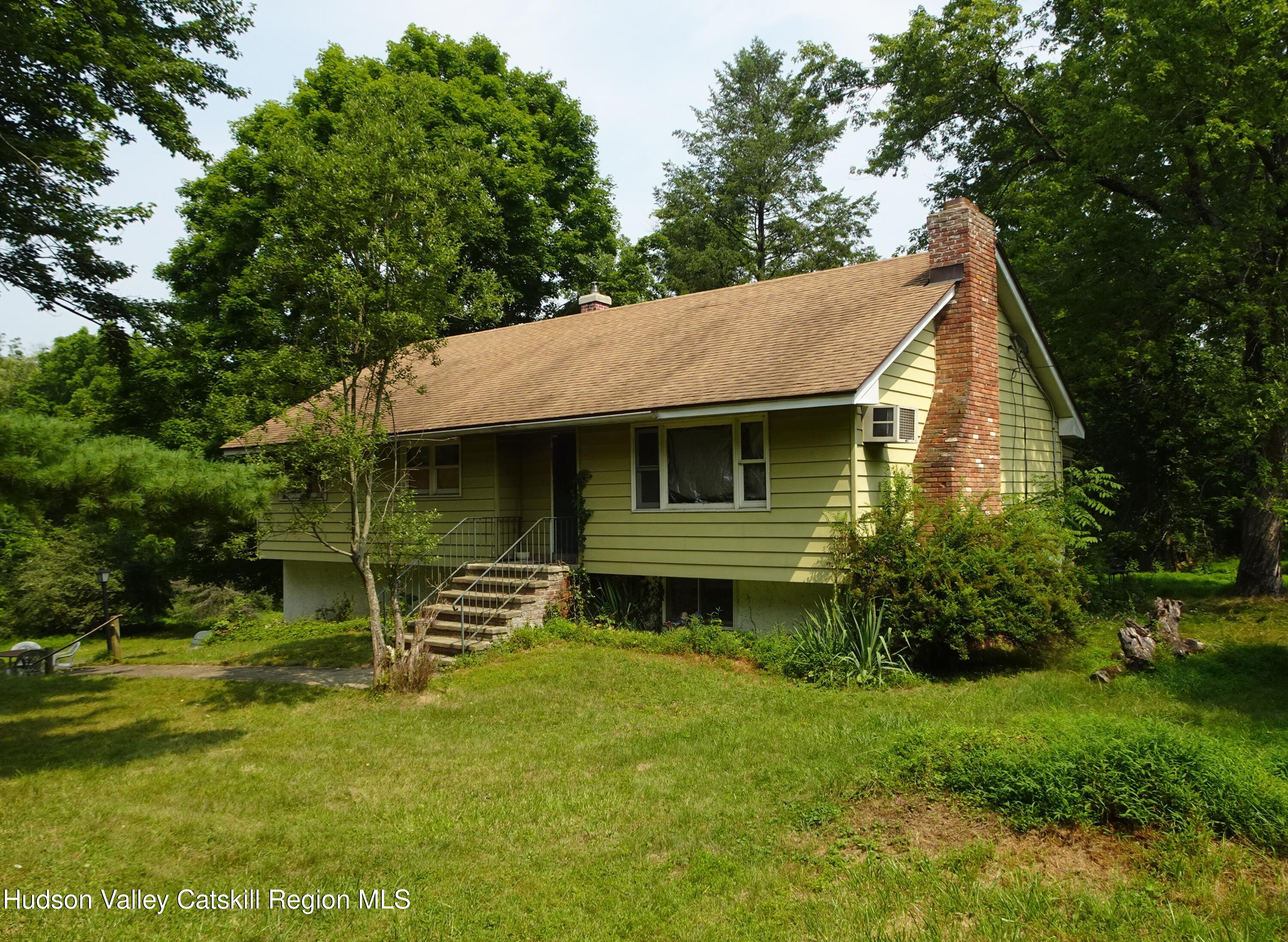 7 Old County Rte 27 Craryville, NY 12521 - Photo 1 of 39 a front view of a house with a garden