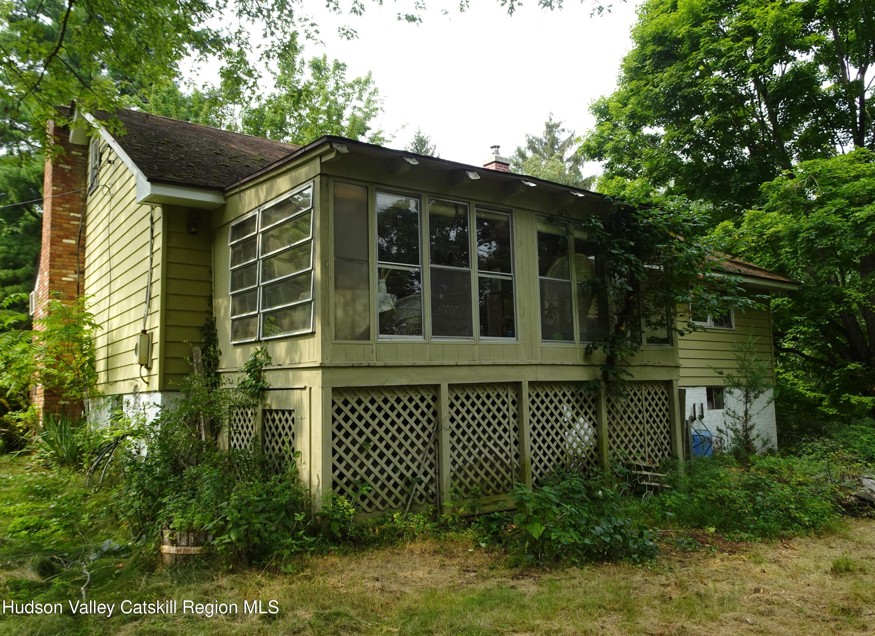 7 Old County Rte 27 Craryville, NY 12521 - Photo 5 of 39 a front view of a house with a garden