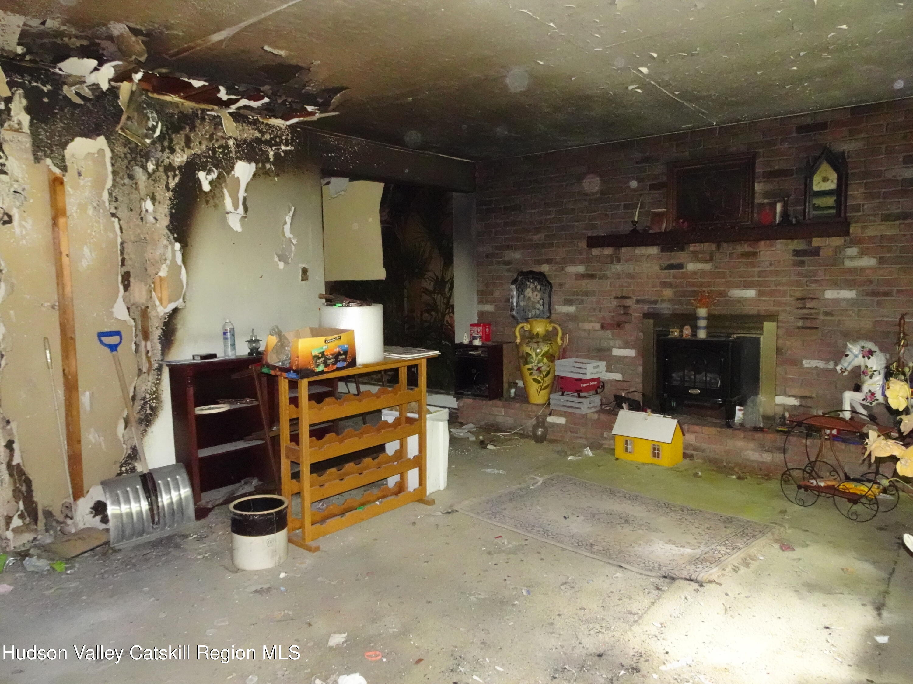 7 Old County Rte 27 Craryville, NY 12521 - Photo 7 of 39 an empty room with a fireplace and painted walls