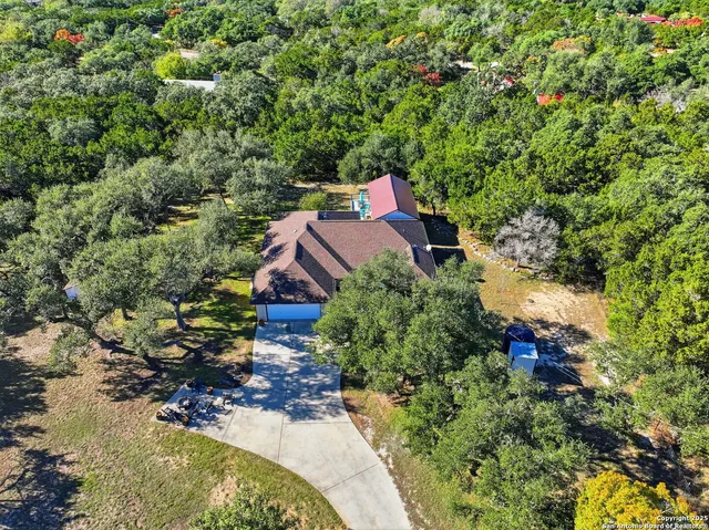 an aerial view of a house with a yard