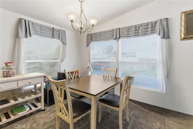 a kitchen with stainless steel appliances granite countertop a sink and a refrigerator