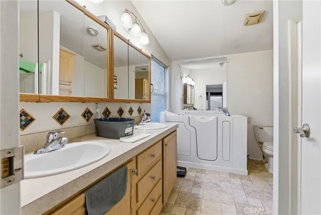 a bathroom with a sink vanity and mirror