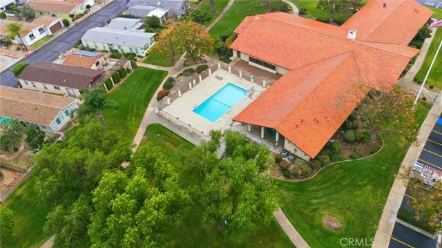 an aerial view of a house with a yard and outdoor seating
