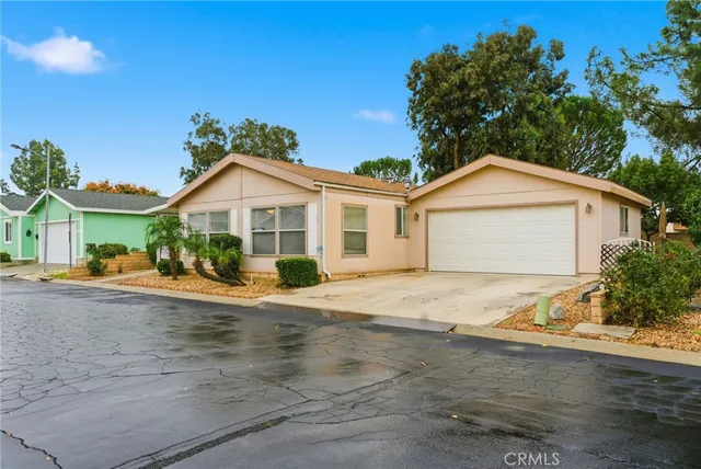 a view of front a house with a yard and garage
