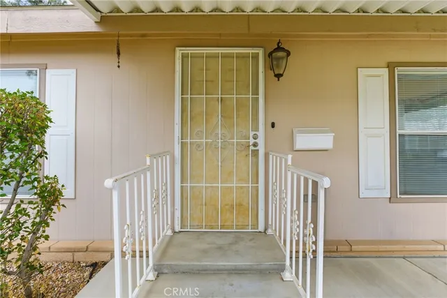 a view of a house with a door and wooden floor