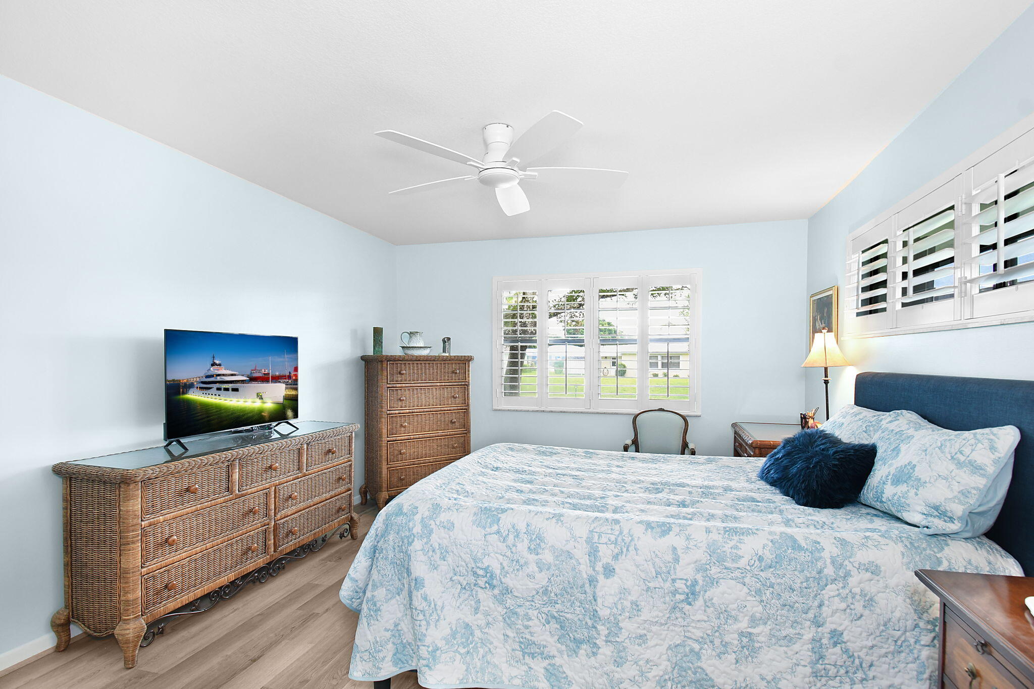 5251 Southeast Sea Island Way Stuart, FL 34997 - Photo 19 of 68 a bedroom with a bed and a flat screen tv