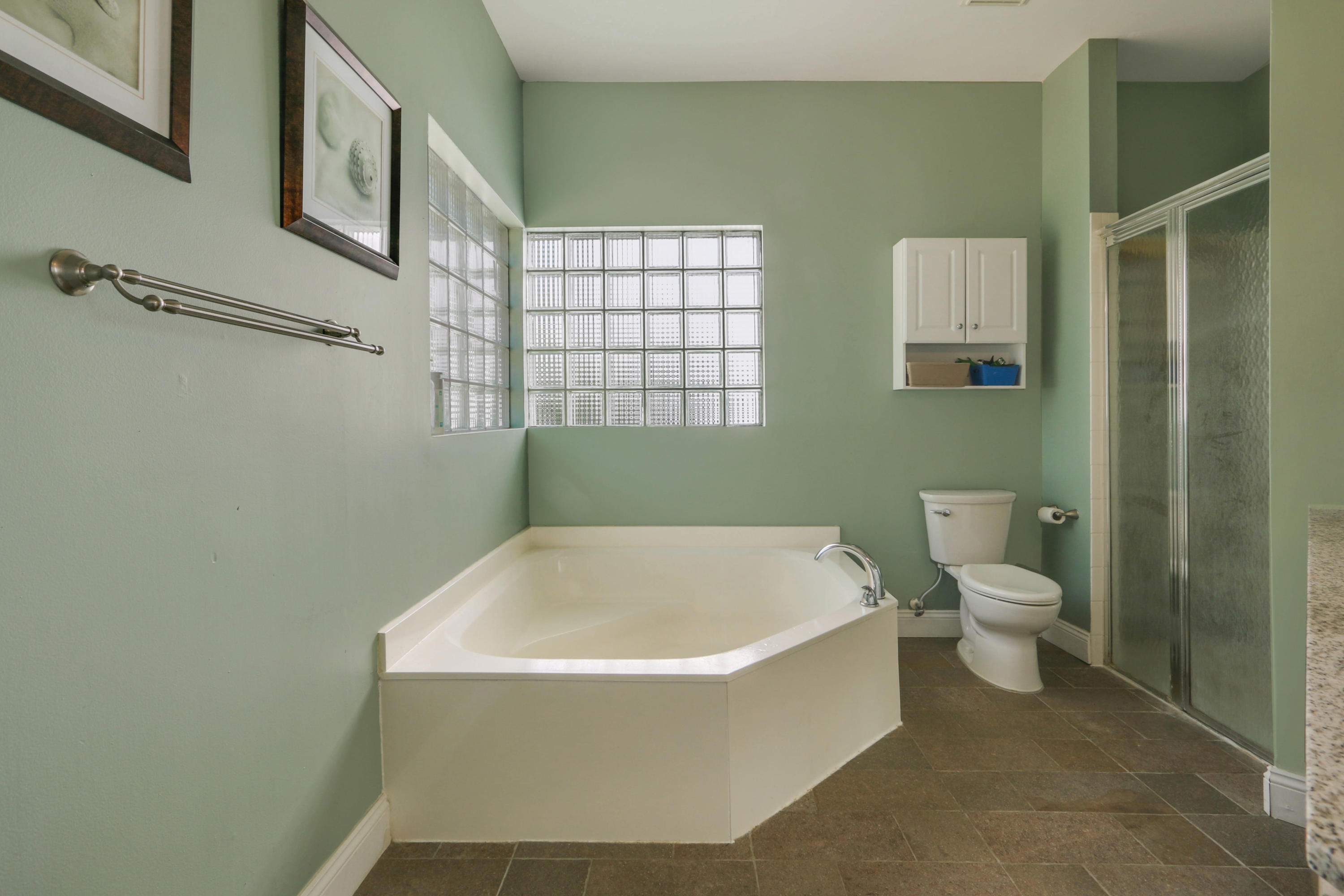 10951 Ravel Court Boca Raton, FL 33498 - Photo 16 of 26 a bathroom with a toilet and a bathtub