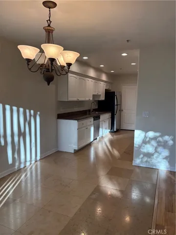 a kitchen with a refrigerator and cabinets