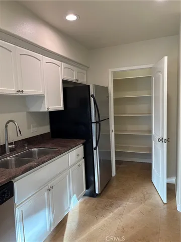 a kitchen with granite countertop a stove and a sink
