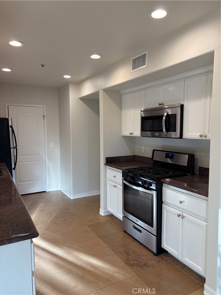 10207 Mountair Avenue, Unit 105 Tujunga, CA 91042 - Photo 13 of 32 a kitchen with granite countertop a stove and a sink