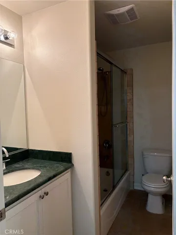 a bathroom with a glass shower door