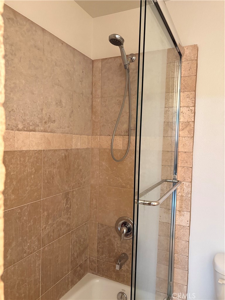 10207 Mountair Avenue, Unit 105 Tujunga, CA 91042 - Photo 17 of 32 a bathroom with a glass shower door