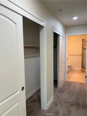a view of entryway with wooden floor and cabinet