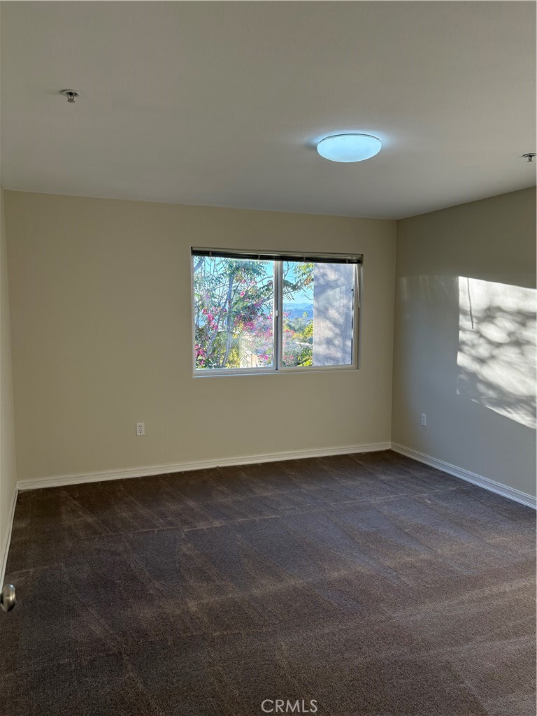 10207 Mountair Avenue, Unit 105 Tujunga, CA 91042 - Photo 26 of 32 an empty room with windows