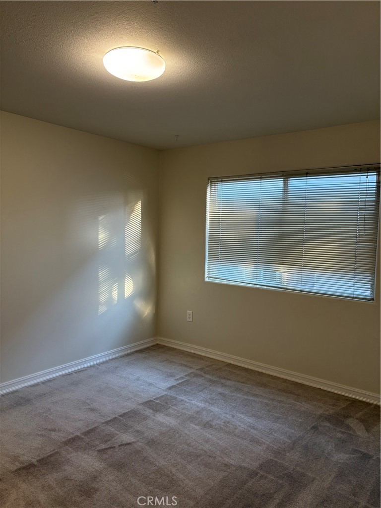 10207 Mountair Avenue, Unit 105 Tujunga, CA 91042 - Photo 29 of 32 an empty room with a empty space and windows