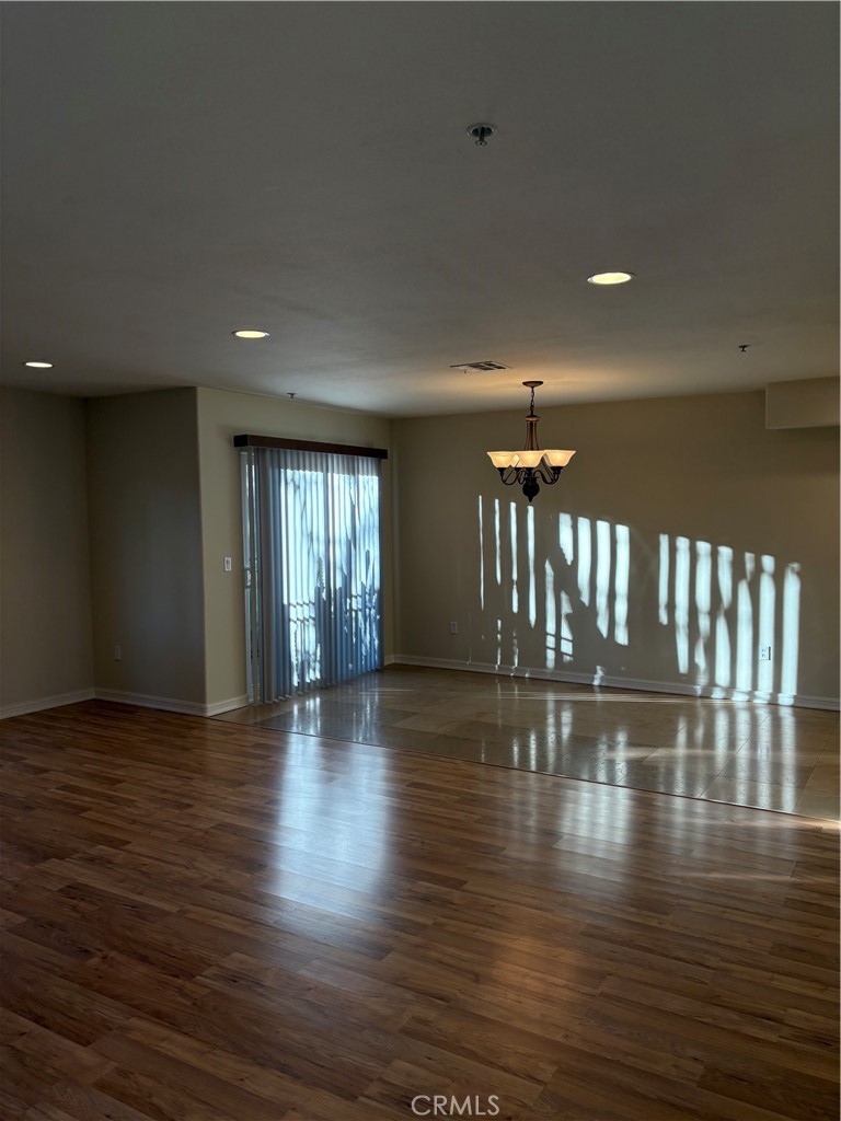 10207 Mountair Avenue, Unit 105 Tujunga, CA 91042 - Photo 8 of 32 a view of empty room with wooden floor