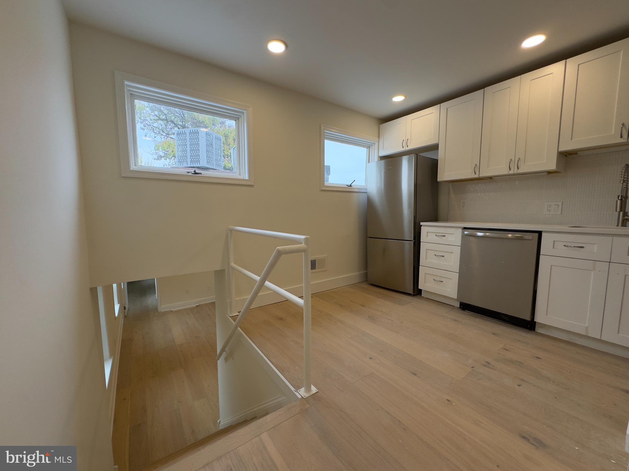1703 Green Street, Unit 7 Philadelphia, PA 19130 - Photo 5 of 12 a kitchen with stainless steel appliances refrigerator and microwave