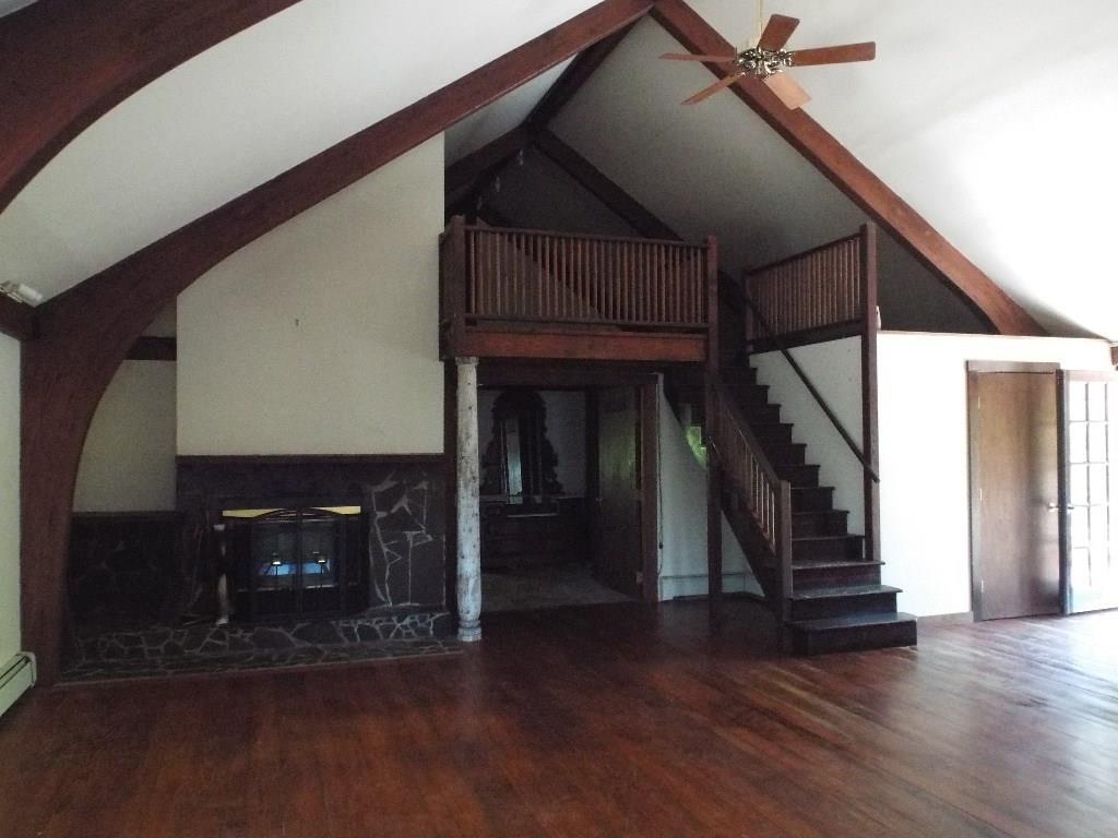 59 Poole's Hill Road Vinalhaven, ME 04863 - Photo 12 of 24 Living room fireplace with stairs...