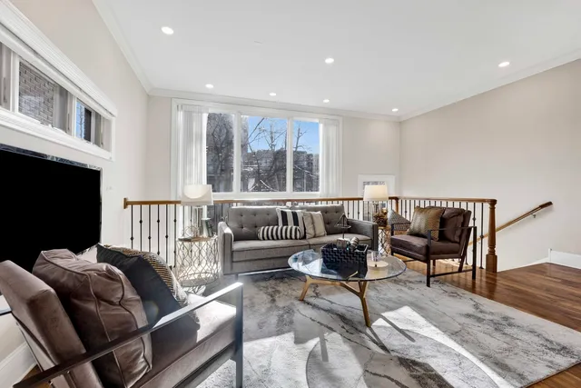 a living room with furniture fireplace and a window