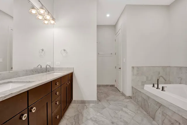 a bathroom with a sink double vanity and a shower