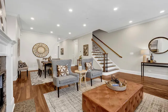 a living room with furniture a rug and a clock