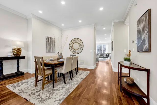 a view of a a dining room with furniture window and wooden floor