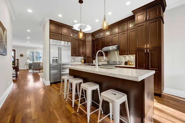 a kitchen with a table chairs refrigerator and microwave