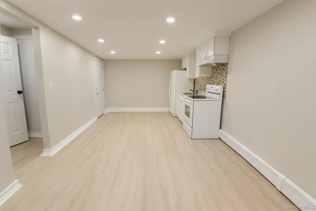 a view of a kitchen with a sink and dishwasher a refrigerator with wooden floor