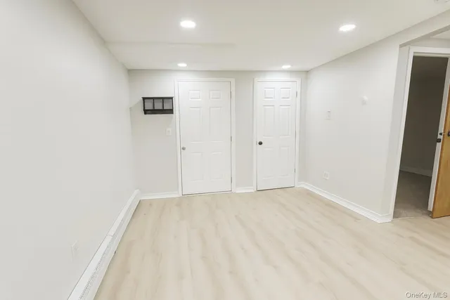 a kitchen with white cabinets and white appliances