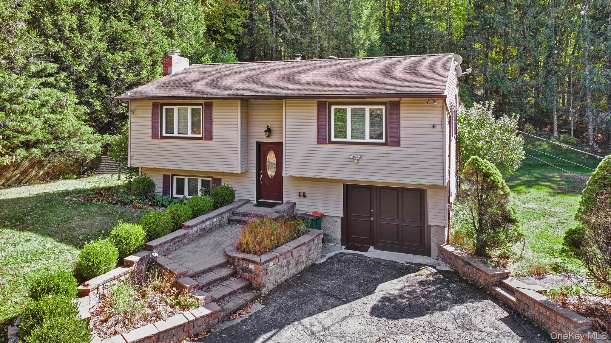 135 Barrett Hill Road Carmel, NY 10512 - Photo 2 of 37 a front view of a house with garden