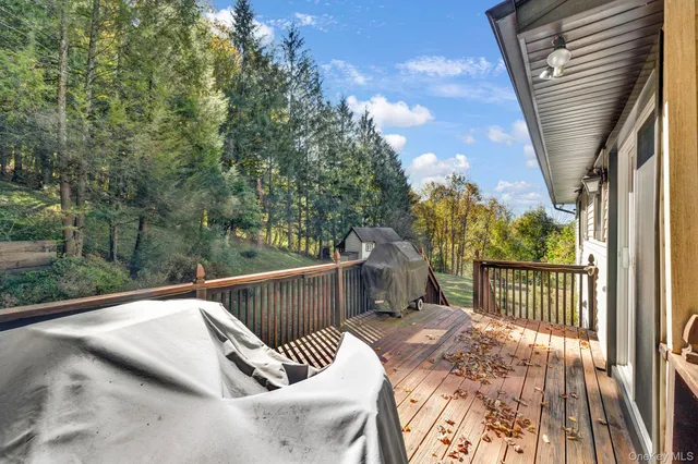 a balcony with wooden floor and outdoor space