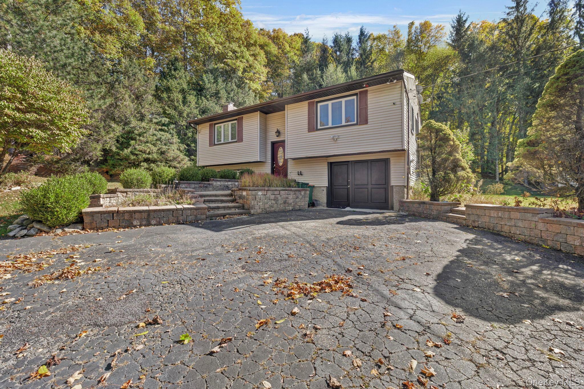 135 Barrett Hill Road Carmel, NY 10512 - Photo 31 of 37 a front view of a house with a yard and garage