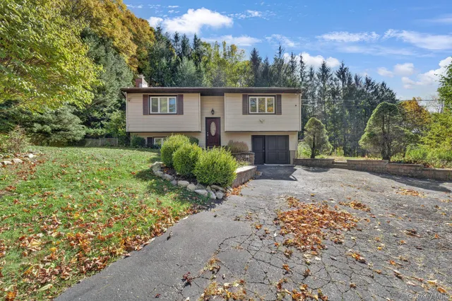 a view of a house with a yard and garage