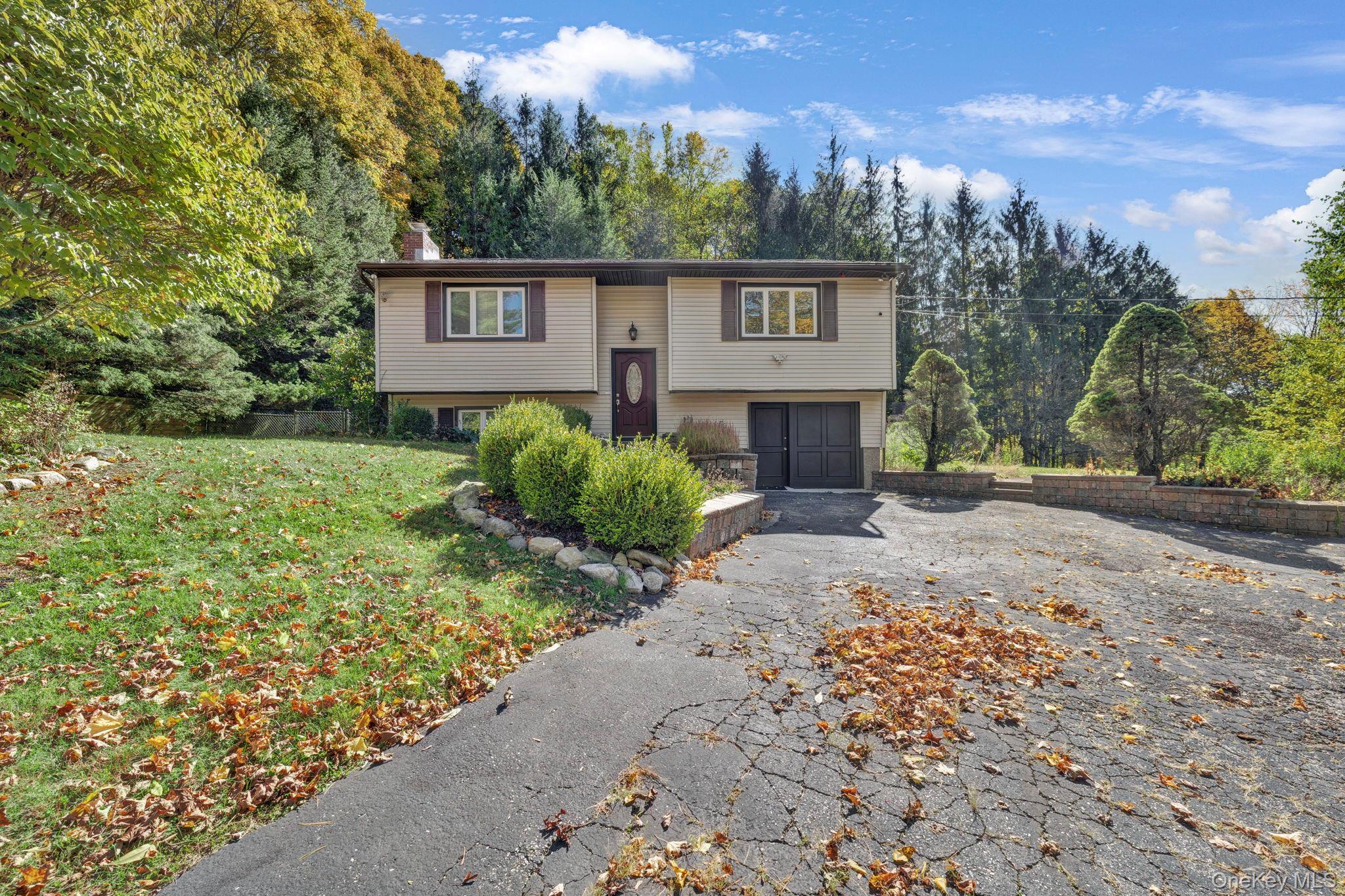 135 Barrett Hill Road Carmel, NY 10512 - Photo 32 of 37 a view of a house with a yard and garage