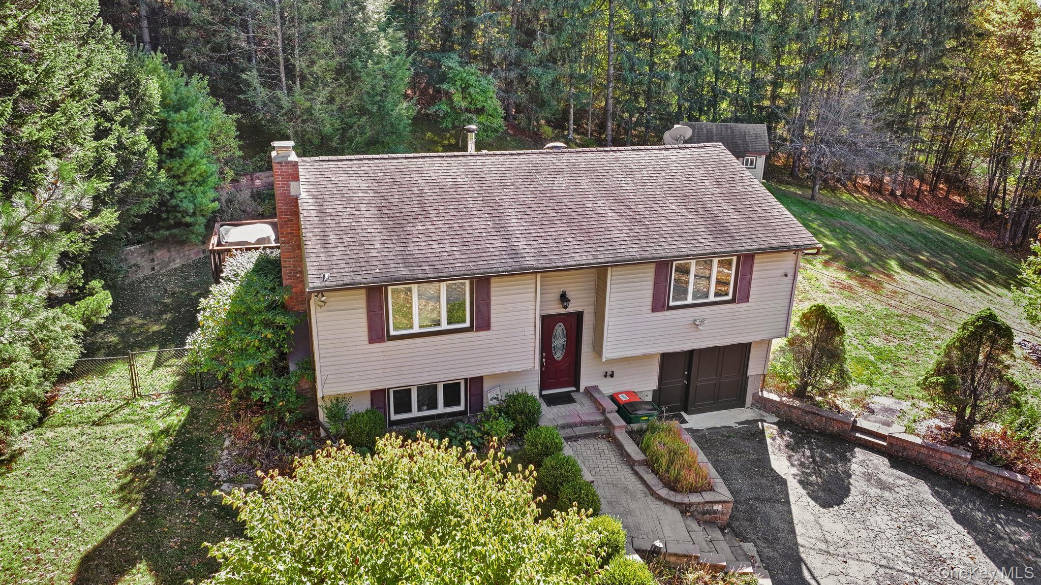 135 Barrett Hill Road Carmel, NY 10512 - Photo 35 of 37 a aerial view of a house with a yard table and chairs