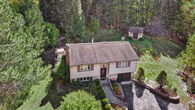 an aerial view of a house with outdoor space and street view