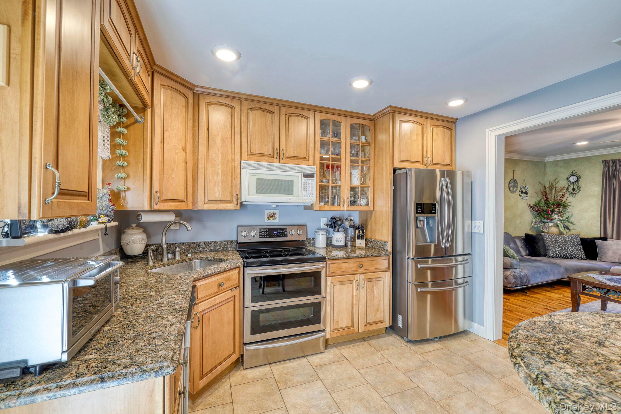 135 Barrett Hill Road Carmel, NY 10512 - Photo 6 of 37 a kitchen with stainless steel appliances granite countertop a refrigerator a stove and a sink
