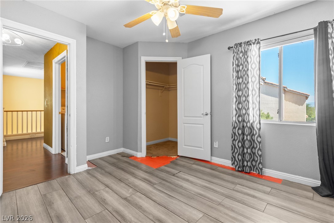 8934 Deep Ridge Court Las Vegas, NV 89178 - Photo 19 of 47 A well-lit interior space features wood plank flooring and a ceiling fan for comfort.