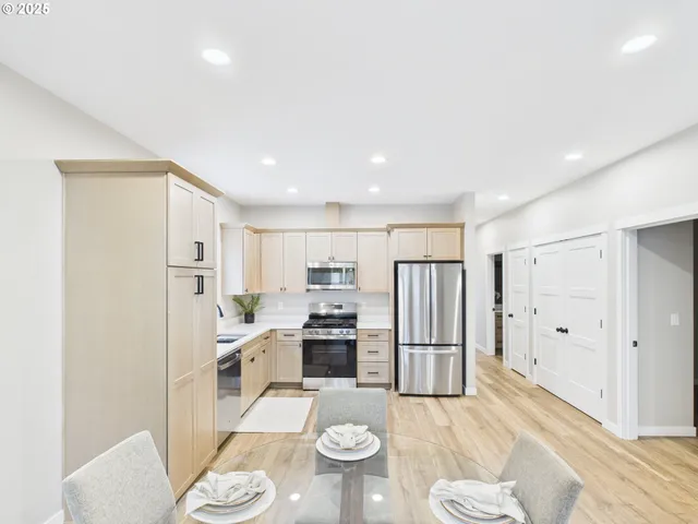 a kitchen with stainless steel appliances granite countertop a refrigerator and a sink