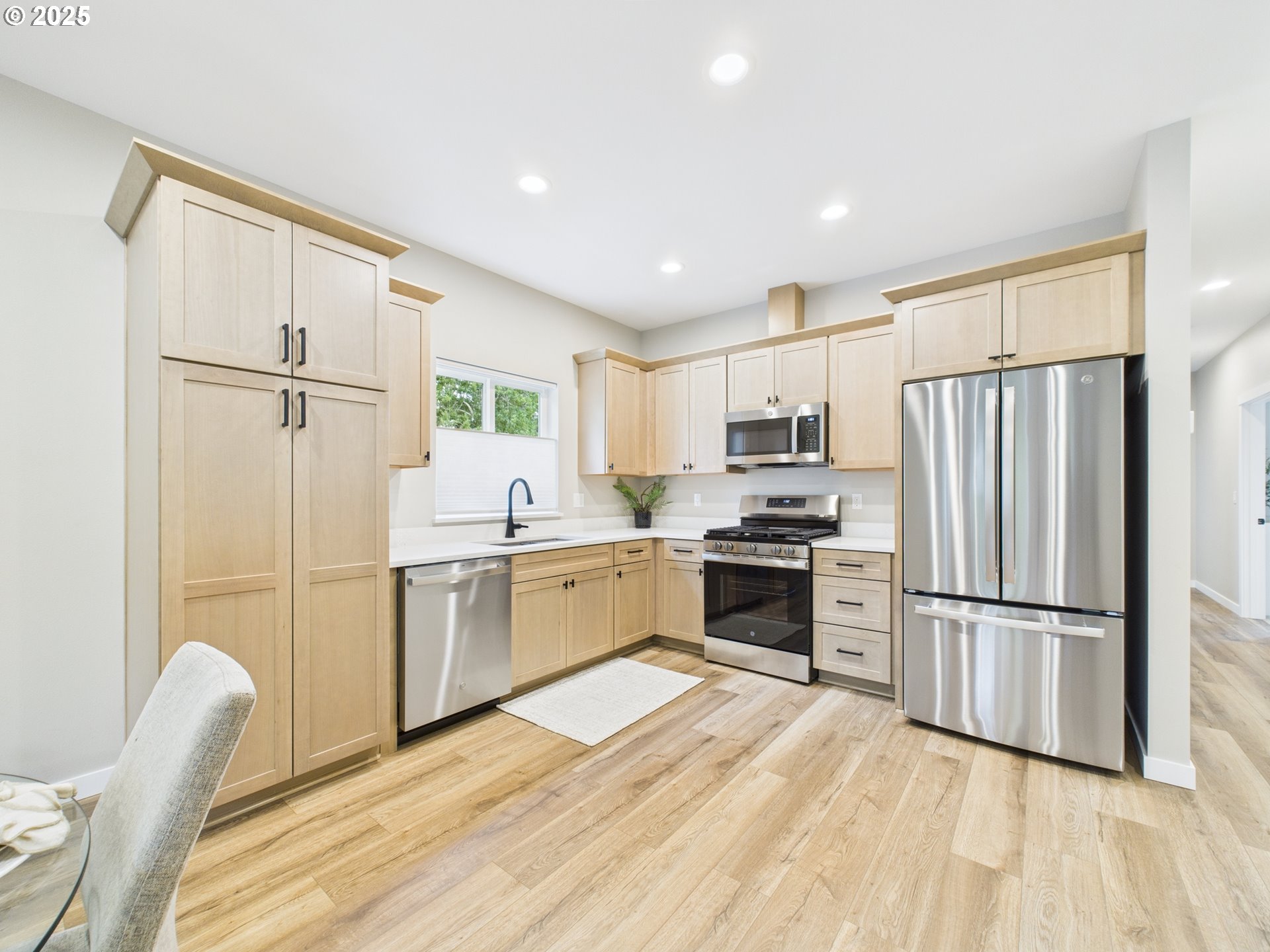 1269 Avenue D Seaside, OR 97138 - Photo 13 of 22 a kitchen with granite countertop stainless steel appliances a refrigerator stove top oven and sink