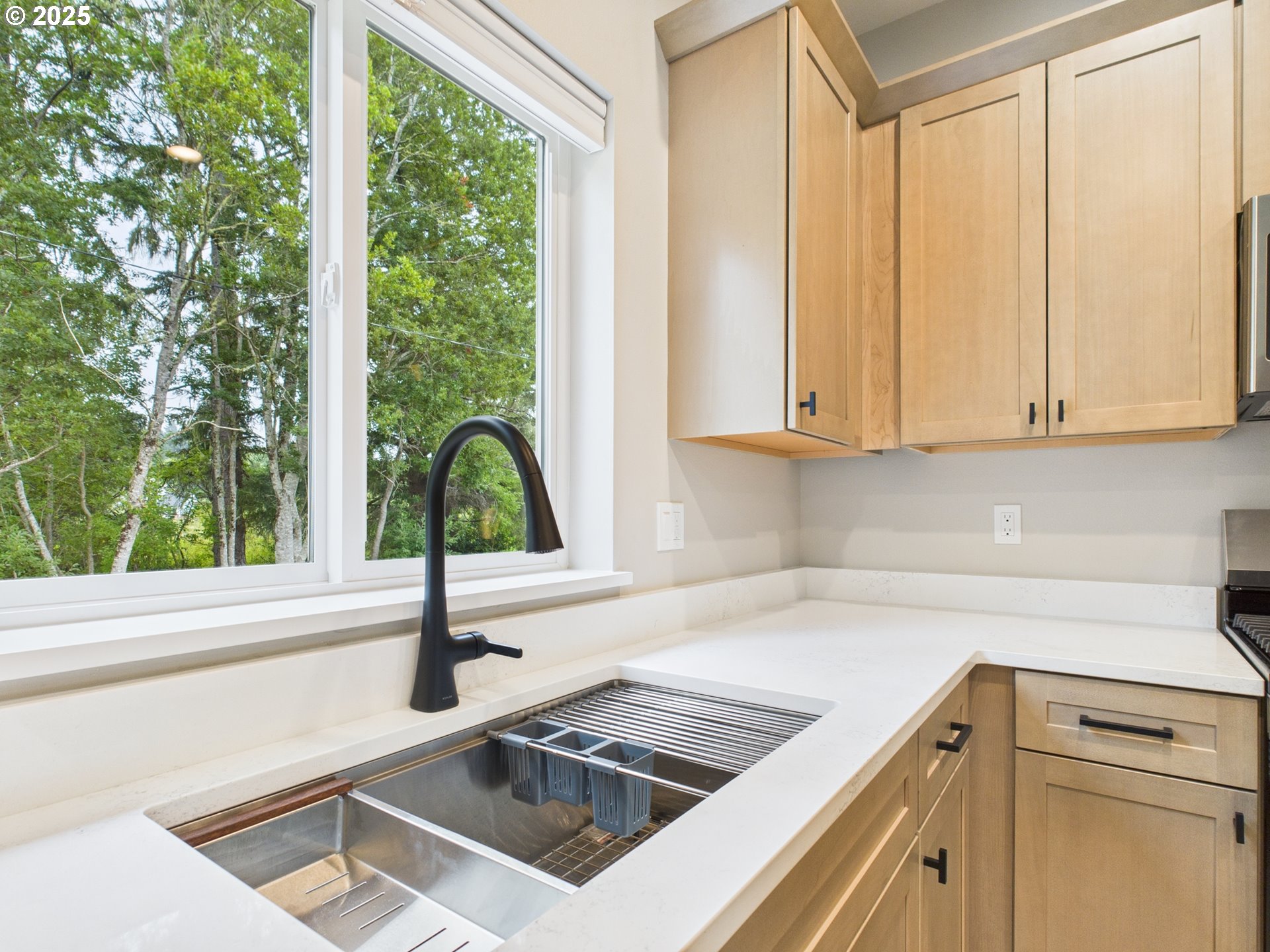 1269 Avenue D Seaside, OR 97138 - Photo 16 of 22 a kitchen with a sink cabinets and a large window