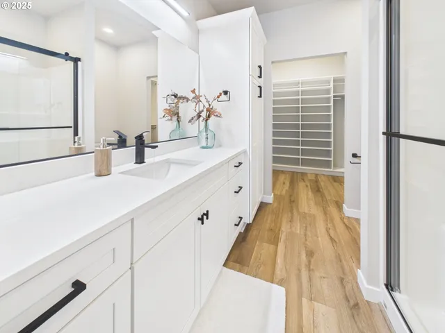 a spacious bathroom with a double vanity sink and a mirror