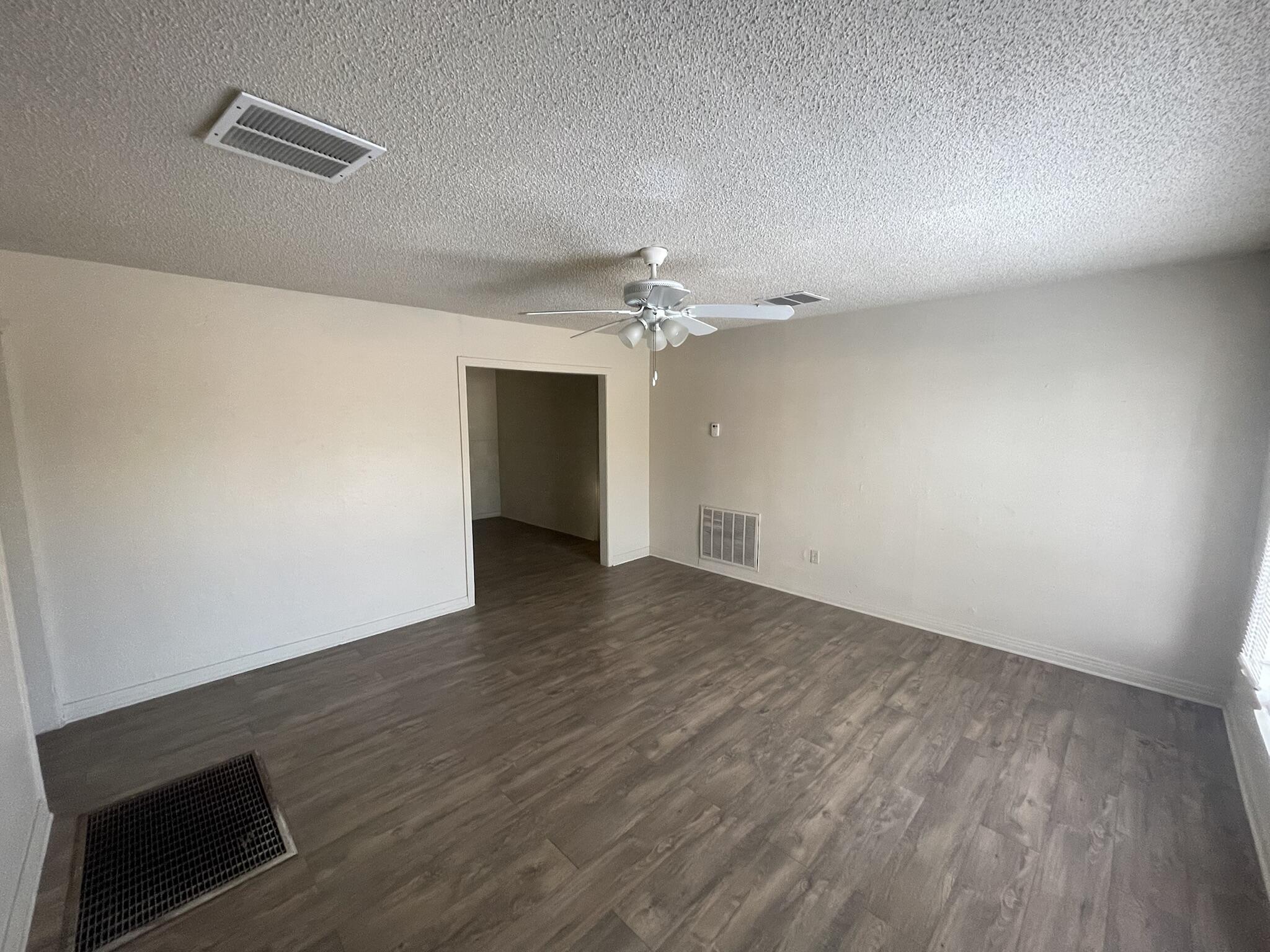 4303 42nd Street Lubbock, TX 79413 - Photo 2 of 10 wooden floor in an empty room